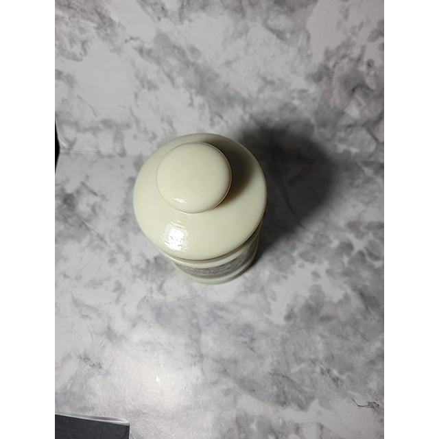 Antique custard glass apothecary jar. This vintage jar makes a great small storage container and is a very unique...
