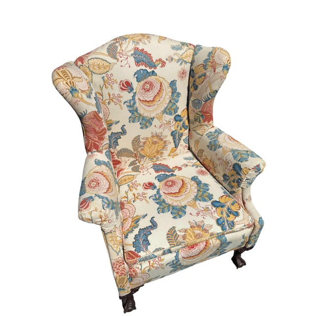 This delightful pair of floral wingback chairs would be charming in a formal living space, a library, or a cozy den....