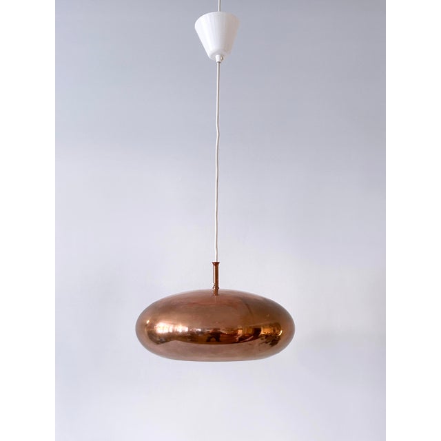 Extremely rare, highly decorative and elegant mid-century modern solid copper pendant lamp or hanging light. Manufactured...