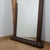 An Art Deco over mantel mirror with macassar ebony frame and a fluted, angled base. Dimensions: H 143cm W 118cm D 11cm...