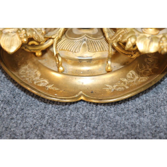 This highly decorative French Louis XVI-style gilt-brass and porcelain Bouillotte lamp is an unusually elaborate...