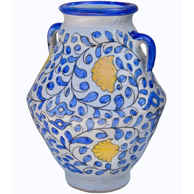 The exquisite silhouette of this very-heavy vase and the vibrant blue and orange color combination are eye-catching...
