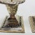 A pair of silverplate candlesticks decorated with swags snd bows with a rope edge around the top. Measurements are 3.75” x...