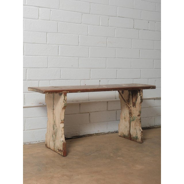 This rustic wooden bench showcases beautifully worn surfaces and layers of original chippy paint that speak to years of...