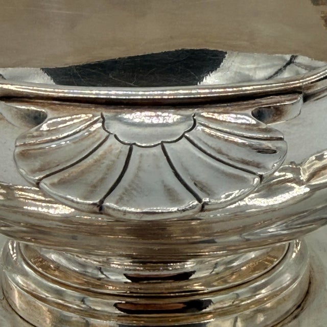 n elegant antique French silverplate gravy boat by Christofle, featuring an integrated underplate that creates a graceful,...