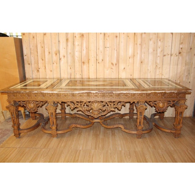 A substantial rectangular console table (carved on all sides) in carved wood, resting on eight openwork tapered legs...