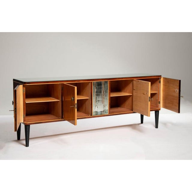 Italian Art Deco sideboard crafted from walnut and maple. It features four doors and a curved central section finished in...
