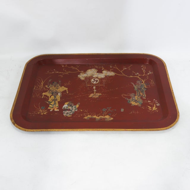 This striking vintage rectangular tray features a vibrant red lacquer finish and an elegant gold painted rim that...