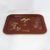 This striking vintage rectangular tray features a vibrant red lacquer finish and an elegant gold painted rim that...
