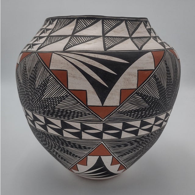An exceptional hand-coiled Acoma Pueblo polychrome storage jar (olla) by Lydia H. Ray, affectionately known within her...