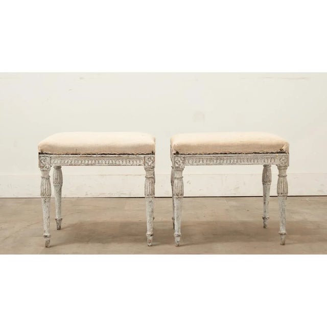 Dimensions: 18 ¼” H x 19 ½” W x 14 ¾” D A Swedish pair of Louis XVI style benches (interchangeable as footstools or...