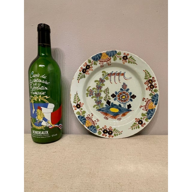 A good 18th Century English Delft Polychrome plate with great colors. Typical wear for this type of plates. Chips on the...