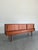 Mid Century Danish Modern Teak credenza or sideboard. Interesting step front design with recessed top featuring 3 sliding...