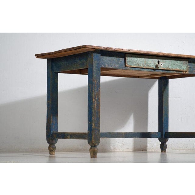 Rustic solid pine work table with a single front drawer, originating from central europe and dating to the turn of the...