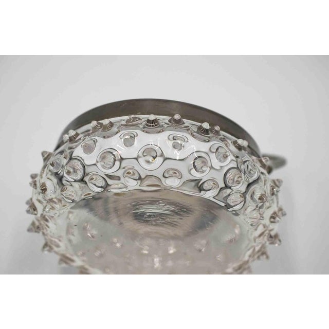 A delicate pressed clear glass bowl with pronounced hobnail decoration throughout, set into a silver-toned metal frame...
