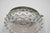A delicate pressed clear glass bowl with pronounced hobnail decoration throughout, set into a silver-toned metal frame...