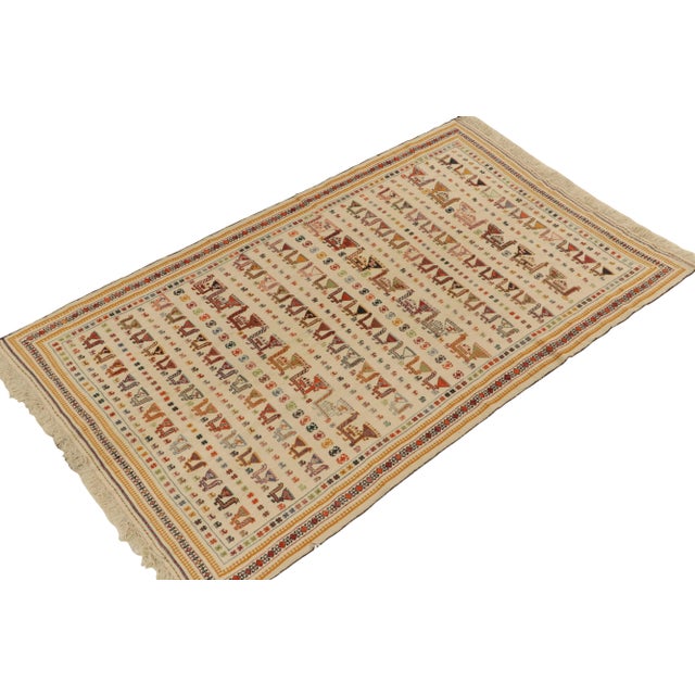 Handwoven in wool circa 1920-1930, a 5x8 antique Verneh kilim rug among our most coveted curations of masterful Persian...