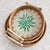 This set of three-piece round trays is handmade by Vietnamese craftsmen. It uses a natural rattan woven outer ring and is...