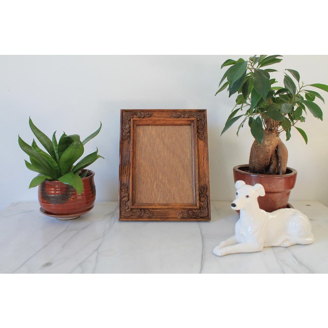 Vintage ornate 5"x7" carved wood picture frame. No makers mark. Minor age wear.