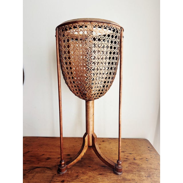 Antique circular carved rim fruitwood plantstand clad in cane over interior wooden skeleton atop a tripod base. Three...