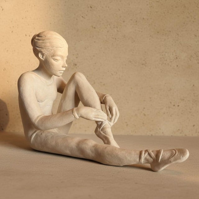 Austin Productions' 1983 Seated Ballet Dancer, often called Ballerina Tying Pointe Shoe, captures the quiet ritual before...