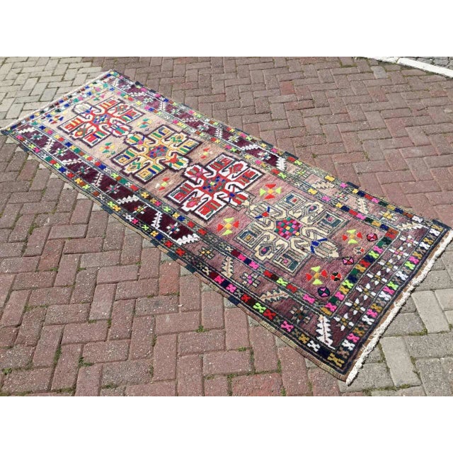 This gorgeous hand knotted vintage Anatolian runner rug is approximately 70 years old in excellent vintage condition. The...