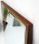Pair of outstanding quality Mid-Century Modern neat beveled edge brass and walnut frame boat shape mirrors atr. to Paul...