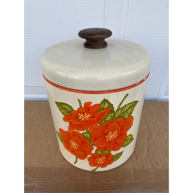 Authentic original Ransburg heavy gauge tin canister. Striking Burnt Orange flowers on a creamy custard colored...