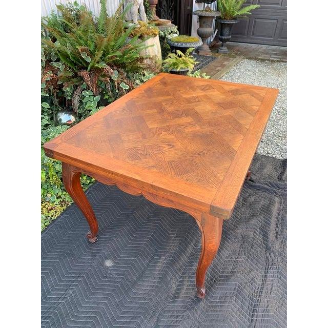 Here we have a vintage French Provincial style oak draw leaf dining table. Beautiful parquet top with two pull out leaves,...