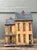 This stately large-scale wooden birdhouse is a masterclass in rustic Americana folk art. Designed with a charming multi-...