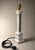 The alabaster lamp features a slender and elegant shape, with a tapered base reminiscent of a column. The body is made of...