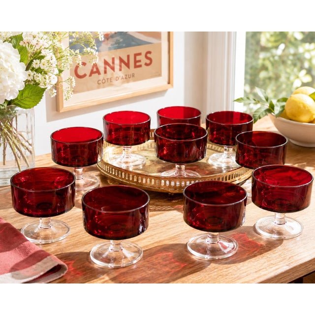 Elevate your entertaining with this beautiful set of ten vintage Luminarc Cavalier Ruby Red coupe glasses, expertly...
