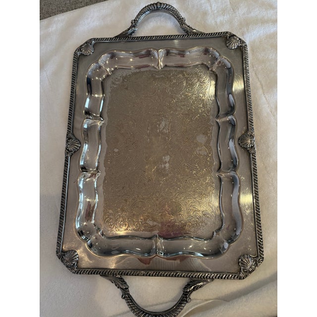 Add timeless elegance to your table or décor with this beautiful vintage silver-tone serving tray. Featuring an ornate...