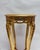 Elegant gold side table with a round marble top and richly decorated base. A special interior piece with a classic French...