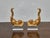 This striking pair of carved giltwood dolphin figures mounted on clear lucite bases likely began their life as decorative...