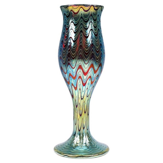 Large, mould-blown vase on a broad foot, widening upwards in a bud-like shape from a slender shaft, with a flared rim...