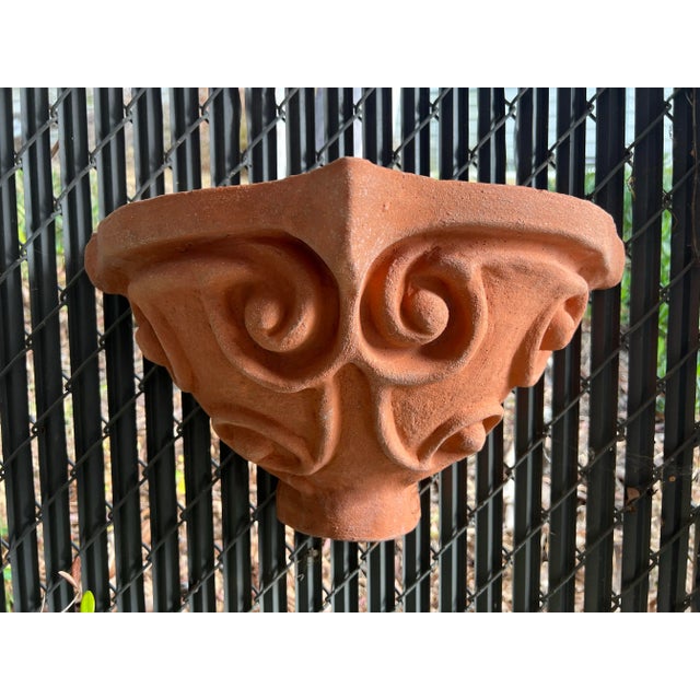 Terracotta wall pocket half vases with stylized fleur-de-lis. They can also be used as sconces. Measures: 19"W x 10.5”H x...