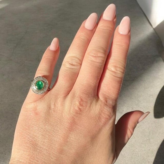 Art Deco Halo Ring, Circa 1935, Natural Emerald and Diamonds in 18k Gold and Platinum An exquisite late Art Deco halo ring...