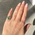 Art Deco Halo Ring, Circa 1935, Natural Emerald and Diamonds in 18k Gold and Platinum An exquisite late Art Deco halo ring...