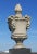 Very rare, monumental Neoclassical style terracotta urn form building finials having a surmounting flame and decorated...
