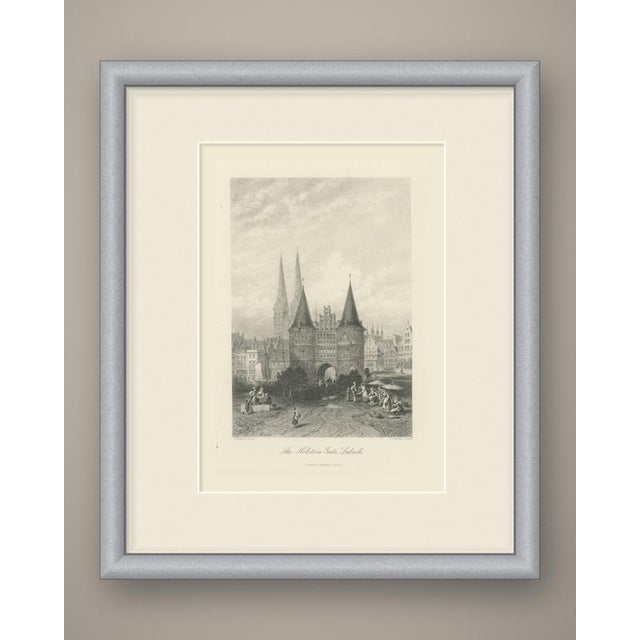 A grand frontal view of the holstein gate at lübeck, its two round towers with tall conical roofs flanking a stepped...