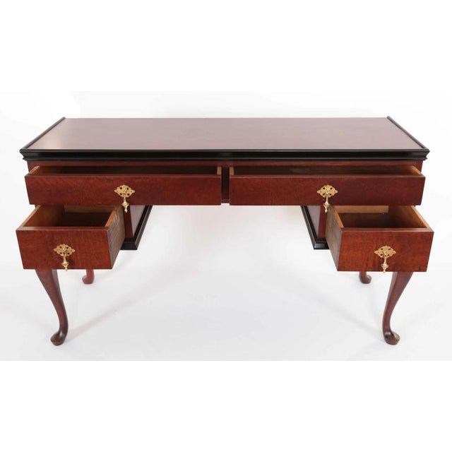 Beautiful wall table made of solid wood refined with mahogany veneer and ebonized moldings. The legs are made of solid...