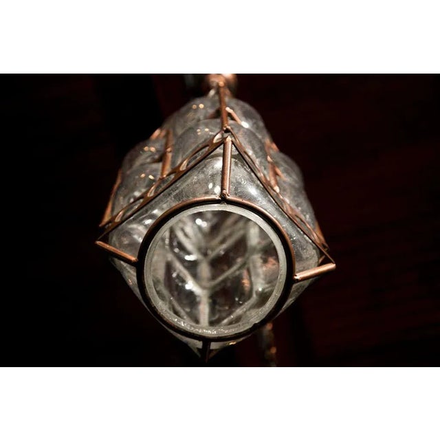 Bronze patinated metal framed bubble blown glass lanterns from Italy.