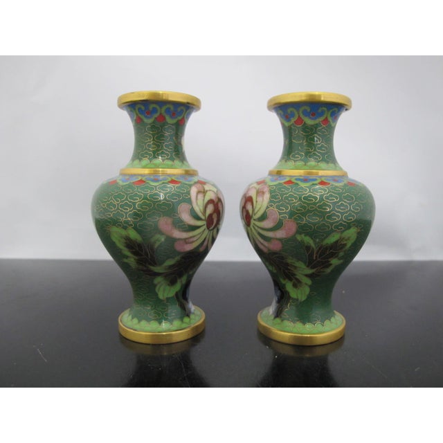 Pair of miniature Chinese cloisonne vases in green enamel with gilt accents and colorful floral motif. Each measures 4"...