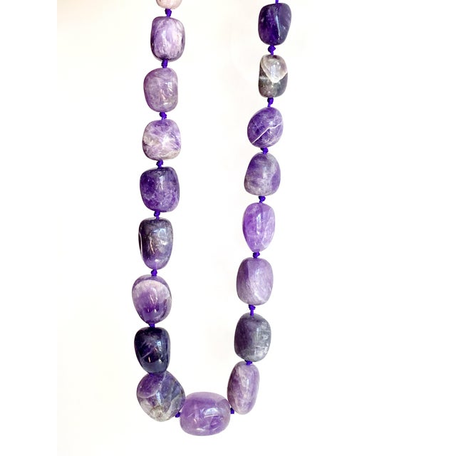 This commanding amethyst statement necklace is a luxurious showstopper, handcrafted with oversized, richly colored...