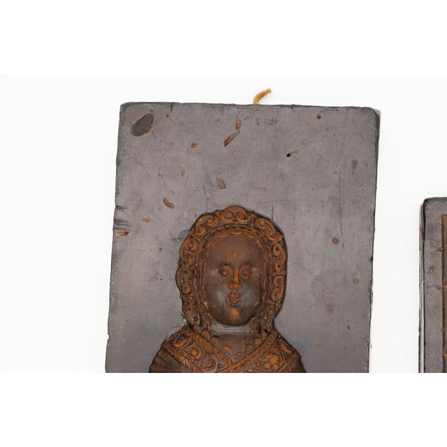 A set of two wax gingerbread molds from early 1900s Germany, featuring one larger mold depicting a baby, and a smaller...