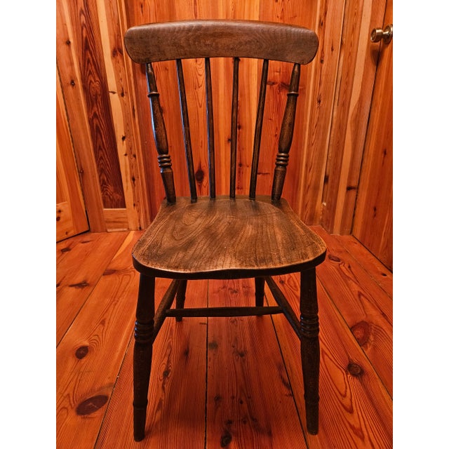 A beautiful antique English Elm side chair from the late 19th century. Solid and strong stick back is full of age,...