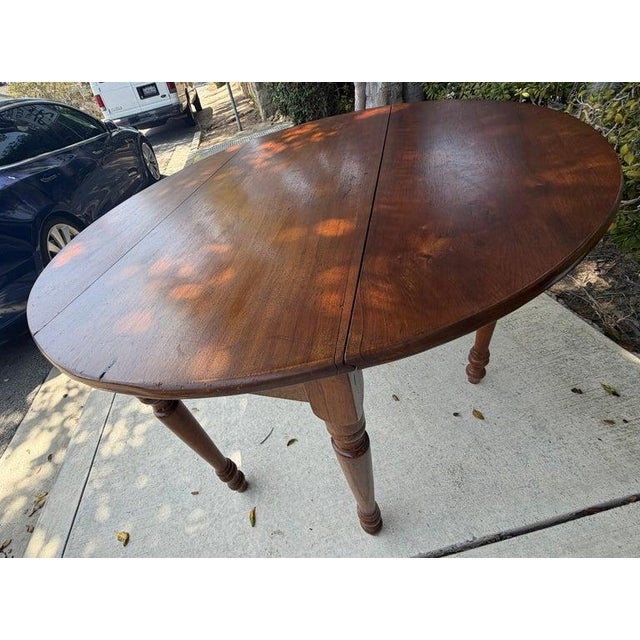 19thc walnut drop leaf table from Ohio. Great patina and amazing construction. Great as a center table or a console on a...