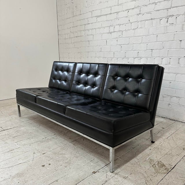 Knoll Black Vinyl Sofa by Florence Knoll The sofa features an iconic armless design by Florence Knoll with a modern chrome...