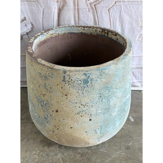 Monumental 20th century terra cotta garden urn. Classic soufflé form with thick rolled rim and textured stone-like body....